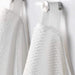 A close-up image of a folded white hand towel with a textured pattern70168468