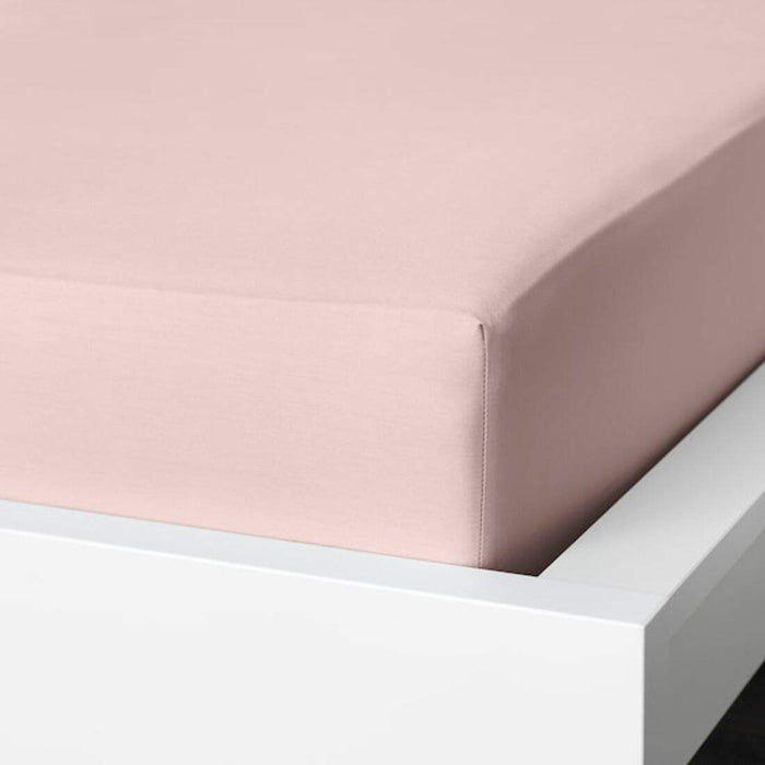 A closeup image of IKEA fitted sheet on a bed with neatly tucked corners and a smooth surface -10357669