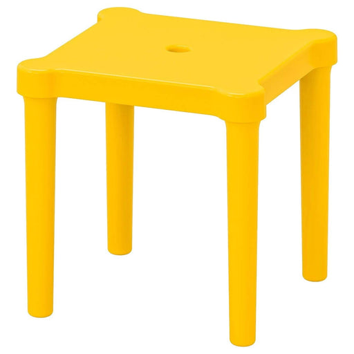 IKEA children's stool with a white plastic seat and legs in a bright green color, placed outdoors on a patio. Alt text: "IKEA children's outdoor stool with green legs and white seat.