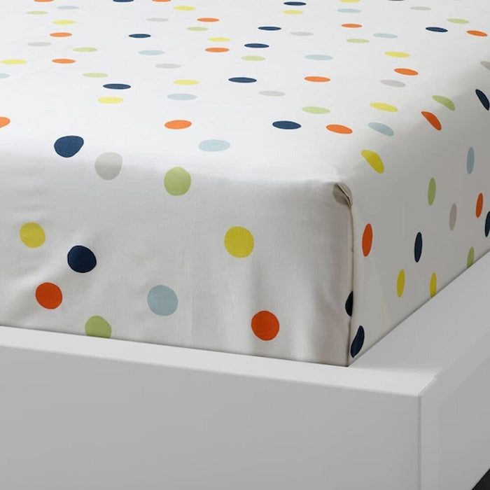 Multicolor cotton flat sheet and pillowcase from IKEA draped on a bed  20454783
