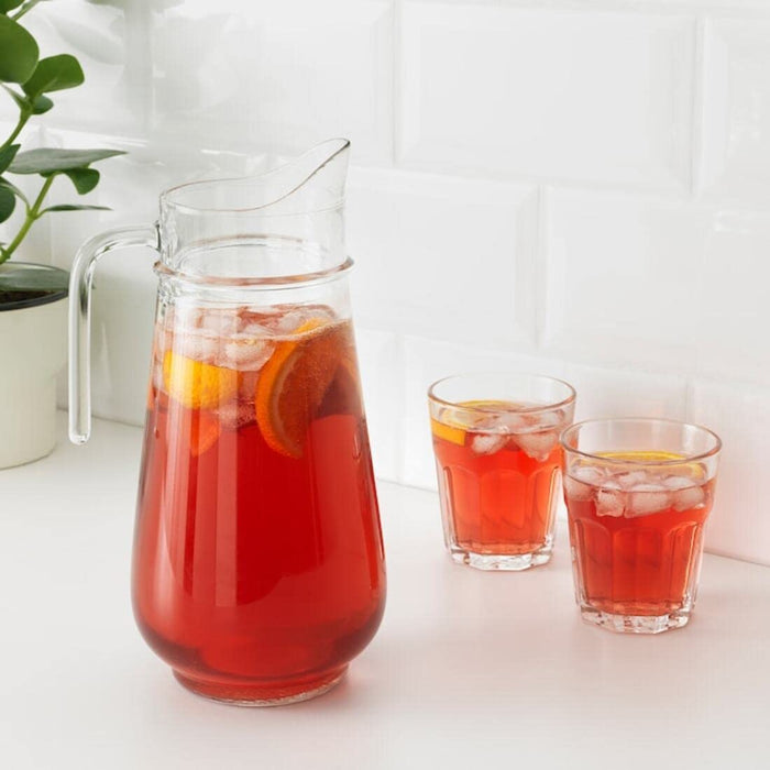 Refreshing lemonade served in a clear glass jug, perfect for outdoor gatherings and warm weather. 10362406