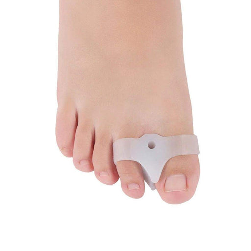 A bunion corrector toe straightener being worn by a person to reduce friction and pain.