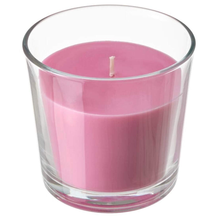 A close-up of an IKEA scented candle in glass, with a flickering flame and a subtle fragrance.