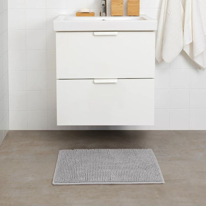  IKEA bath mat placed on a bathroom floor, featuring a soft and absorbent texture and a non-slip bottom for secure footing 70422271
