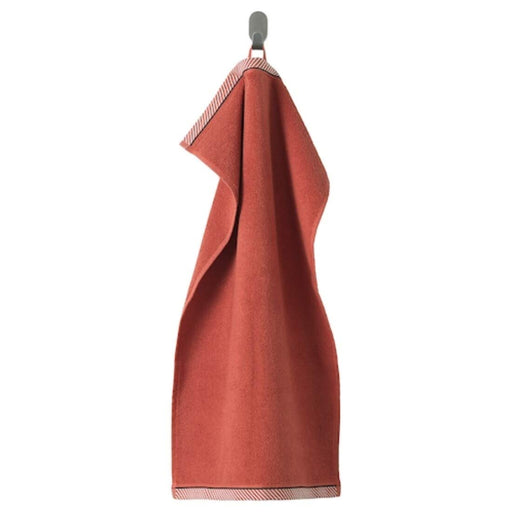 A red hand towel with a soft, smooth texture 50405159
