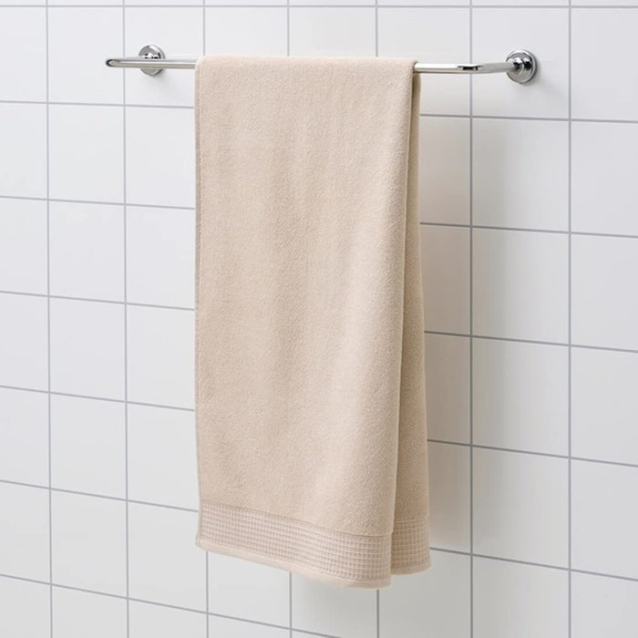 A soft light yellow bath towel, 70x140 cm, draped over a shower rod.30508318       