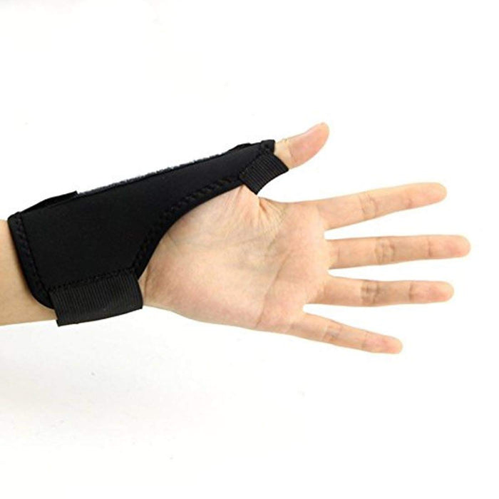 A person wearing a hand and wrist pain relief brace on their left hand, with their thumb and fingers free.