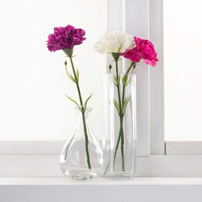 "An IKEA porcelain vase with pink and purple peonies 