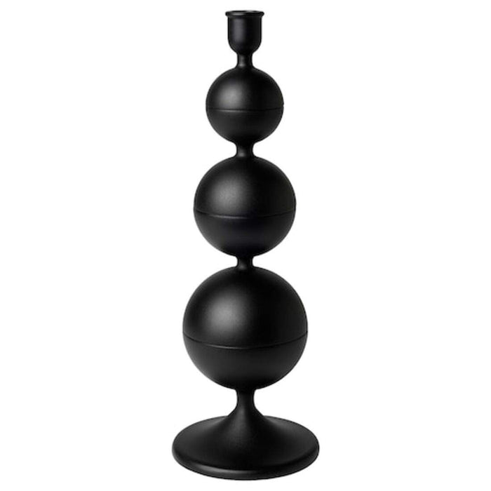 A minimalist black metal IKEA candlestick holder with a single tall candle 60472469
