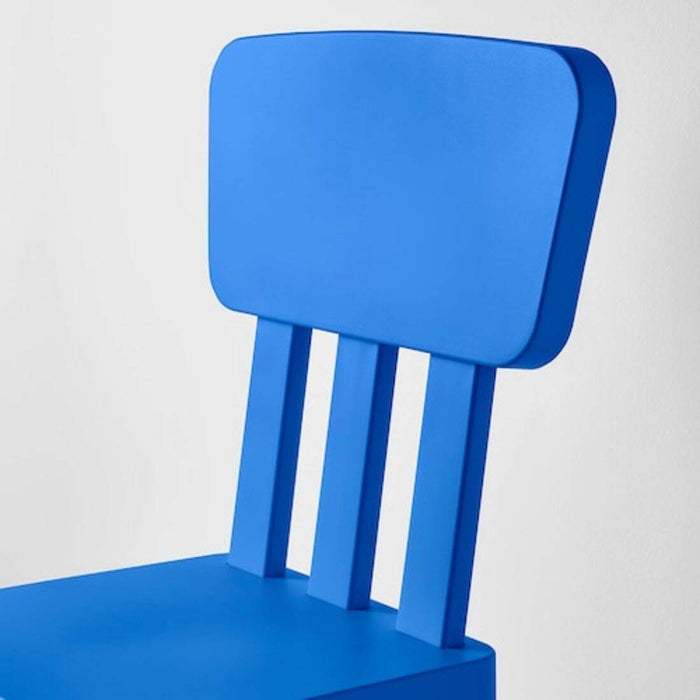 "A blue IKEA children's chair on a sandy beach
