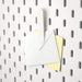 A close-up of an IKEA pegboard clip, emphasizing its simple and functional design. 70321615
