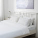 White cotton flat sheet and pillowcase  from IKEA on a bed 70475132
