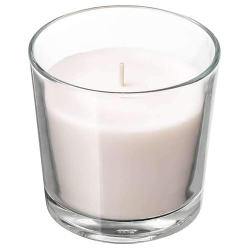 A scented candle in an elegant glass holder, perfect for creating a warm and inviting atmosphere in any room.