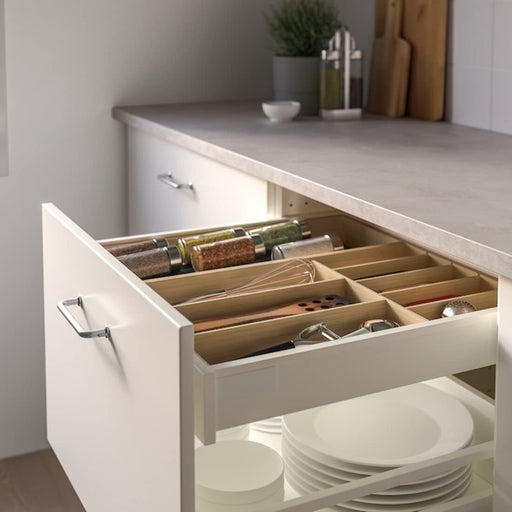 A sustainable and eco-friendly bamboo cutlery organizer from IKEA, perfect for kitchen drawer organization