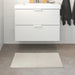 IKEA White bath mat placed on a bathroom floor, featuring a soft and absorbent texture and a non-slip bottom for secure footing 70500141