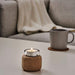 A tealight holder in a cylindrical shape, made of clear glass with a decorative metal rim on top and bottom.70454832