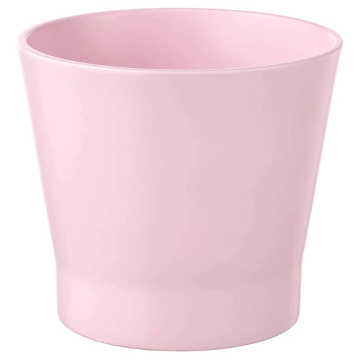 A pink round plant pot with a sleek and modern design.