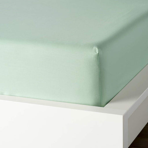 A closeup image of IKEA fitted sheet on a bed with neatly tucked corners and a smooth surface-50459736