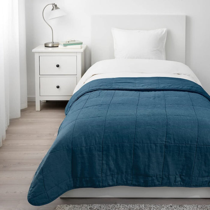 Soft and cozy dark blue bedspread from IKEA, measuring 160x250 cm, folded neatly on a bed.