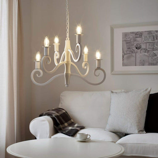 An IKEA 6-arm white chandelier with LED bulbs and frosted glass shades, suspended from a white ceiling 904.768.66