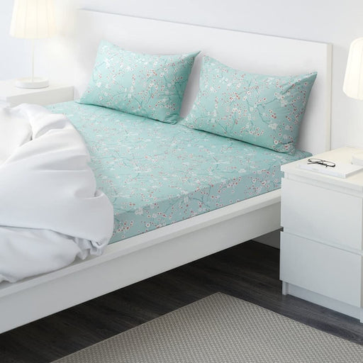 Turquoise cotton flat sheet and 2 pillowcase set from IKEA on a bed 50505564