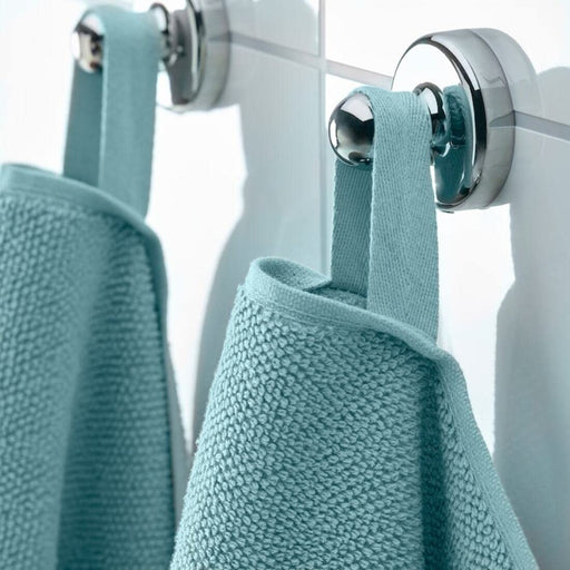 A close-up image of a folded light blue hand towel with a textured pattern and simple, classic hand towel, perfect for every bathroom 80475377