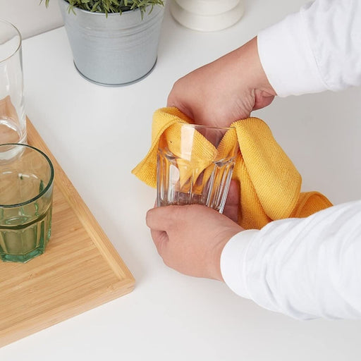 Microfiber cloth being used to clean a glass 50482440
