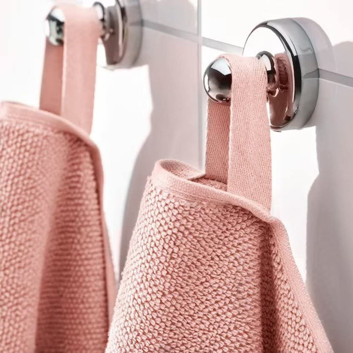 A close-up image of a folded natural hand towel with a textured pattern and simple, classic hand towel, perfect for every bathroom 90475348 