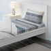 White-blue cotton flat sheet and pillowcase from IKEA on a bed 00493889