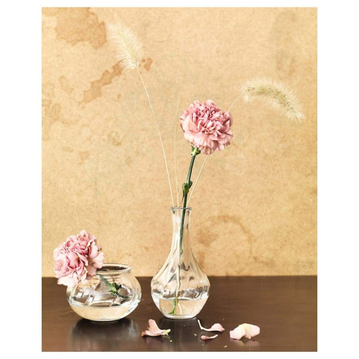 "A pink and white floral arrangement in an IKEA glass vase"