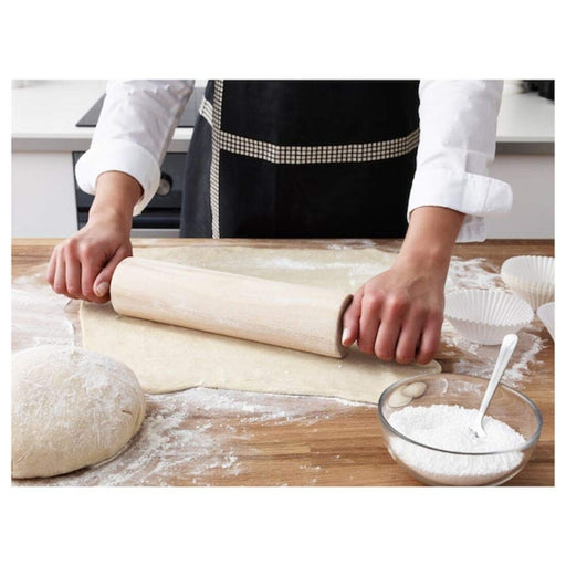 Rolling pin in use to roll out dough for baking  20191942