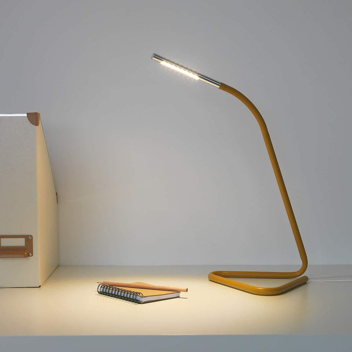 An energy-efficient work lamp from IKEA with a built-in LED bulb and a sleek, modern design.