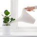 1.2L IKEA watering can in use, pouring water onto a potted plant   40289952