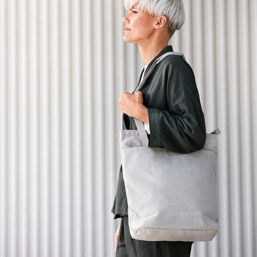 "A beige IKEA tote bag with handles and a front pocket, perfect for everyday use."