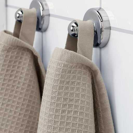 A close-up image of a folded Beige hand towel with a textured pattern 30512886