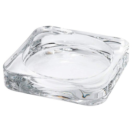 A clear glass dish designed to hold a large pillar candle