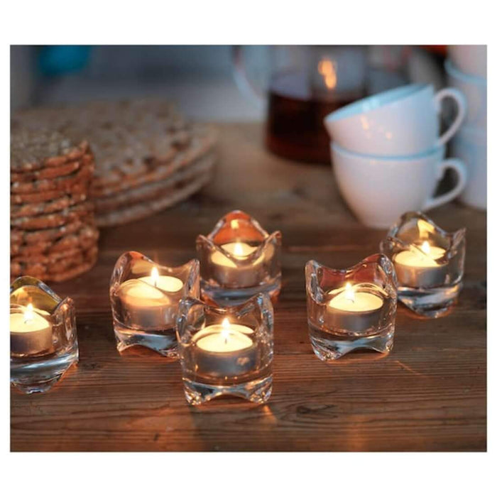 A decorative accent, an unscented candle in a clear glass jar, perfect for creating a serene and tranquil atmosphere in any room.