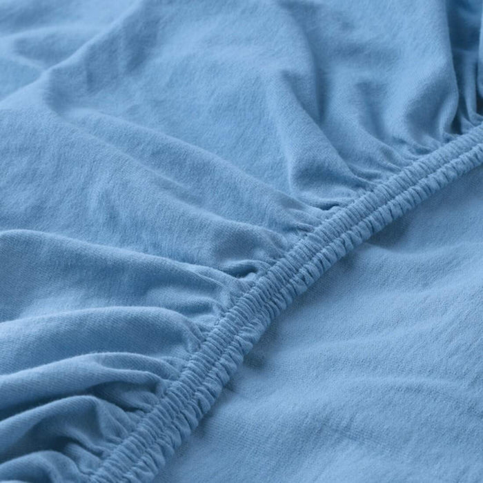 A close-up of an IKEA fitted sheet's elastic edges shows its stretchiness and durability  70427103 