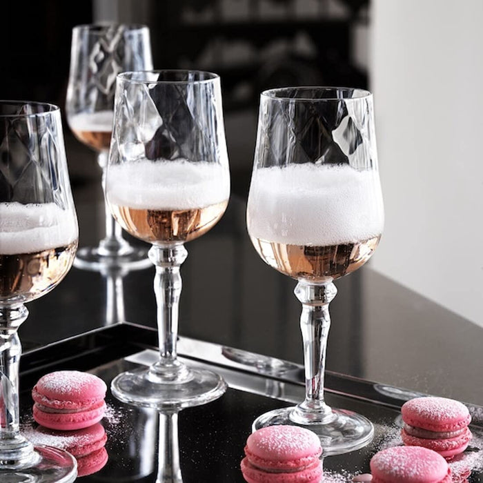 A pair of clear glass wine glasses, perfect for a romantic evening or intimate dinner party.