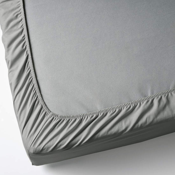 A closeup image of IKEA sheet fits over the corners of your mattress and stays in place thanks to the elastic edging