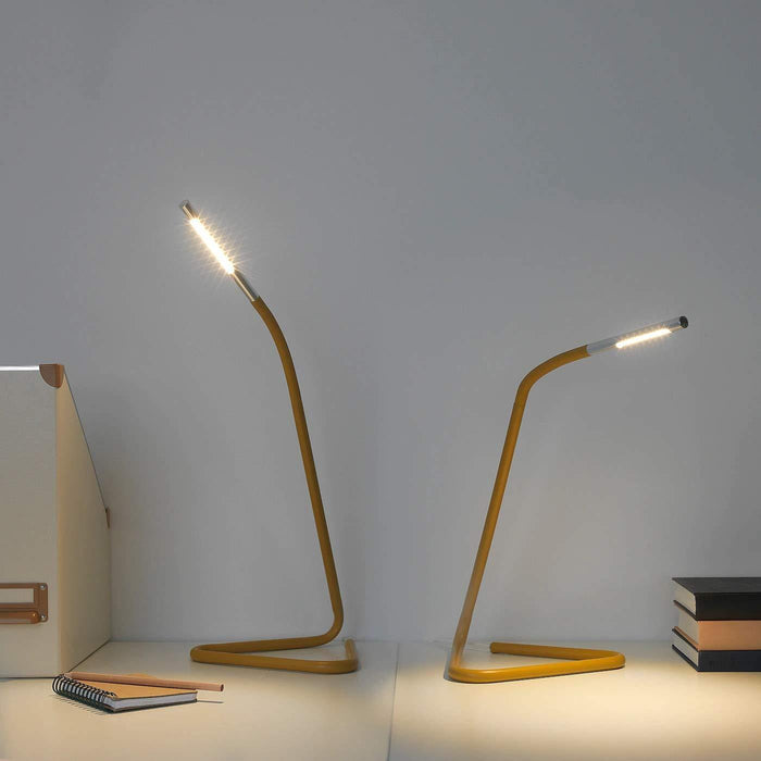 A stylish work lamp from IKEA with a modern design and a brass finish.