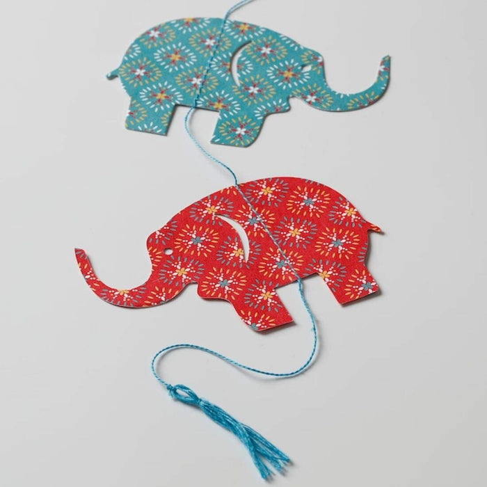 A close-up of the IKEA hanging elephant decoration, showcasing   adorable red heart design 50479211