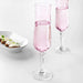 A classic IKEA champagne glass made from clear glass, with a long stem and a narrow, tapered bowl