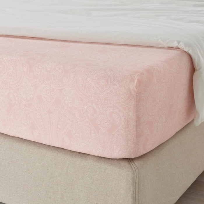 A closeup image of IKEA fitted sheet on a bed with neatly tucked corners and a smooth surface 80501606