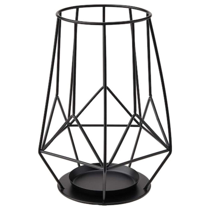 A sleek black metal block candle holder with a round shape, designed to hold a single tea light candle.