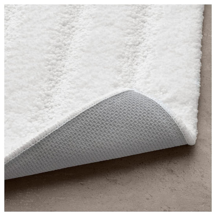 "White IKEA bath mat featuring a soft and absorbent texture, perfect for stepping out of the shower onto 70482967