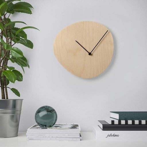A Scandinavian-style IKEA wall clock with a natural wood finish 70358784