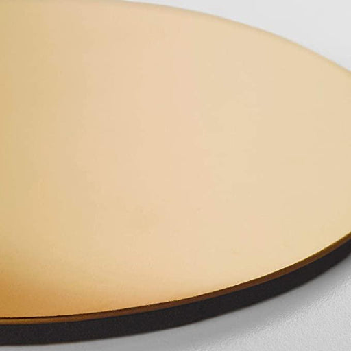  Close-up of single IKEA GLATTIS gold-finish round coaster showing reflective surface and dark EVA backing