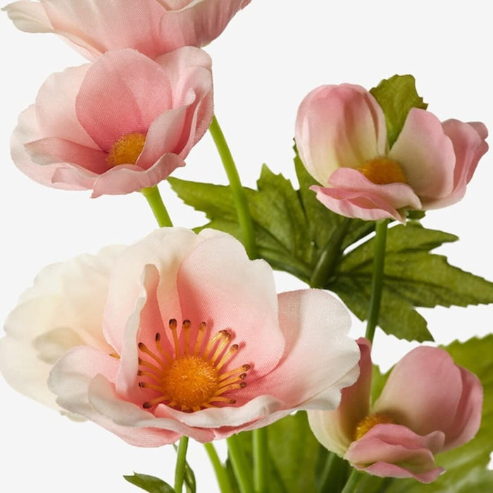 A close-up of a realistic artificial flower with delicate petals in a soft pink hue.