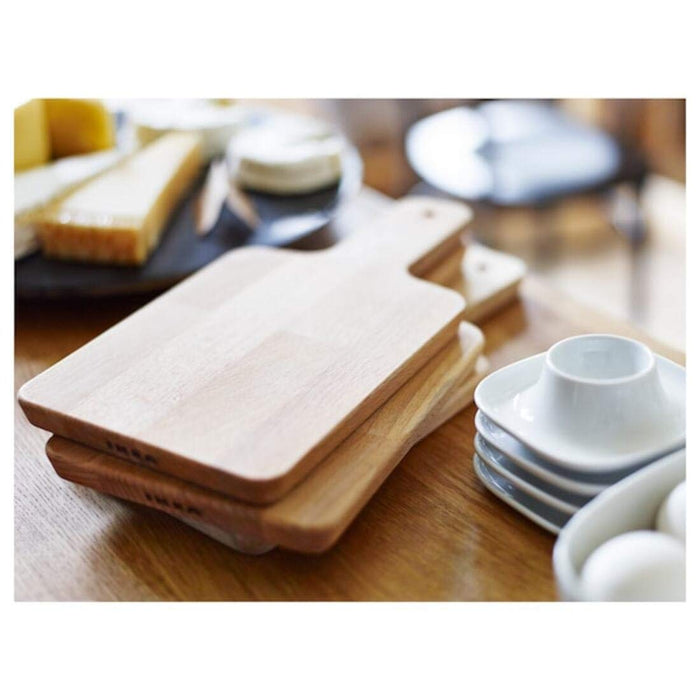 A handy and compact IKEA plastic chopping board with a built-in colander, ideal for rinsing fruits and vegetables.